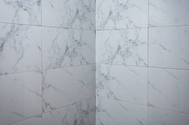 istock Tiling and renovation with marble ceramic tile on cement wall in the house 1400100051