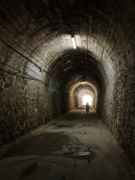 istock Dark tunnel with a person's silhouette 1400101198