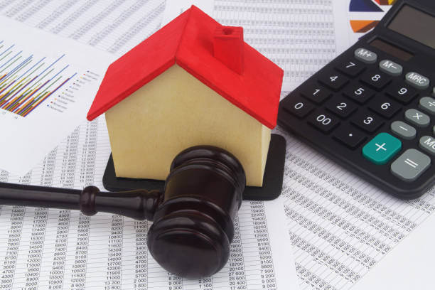 istock Judge gavel and house model with calculator on financial data. 1400101309