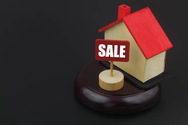 istock House model with banner sale on black background with room for text. 1400101868