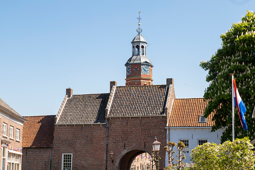Dutch picturesque town of Buren in the Betuwe, with the city gate and the church tower of the Sint Lambertuskerk.
