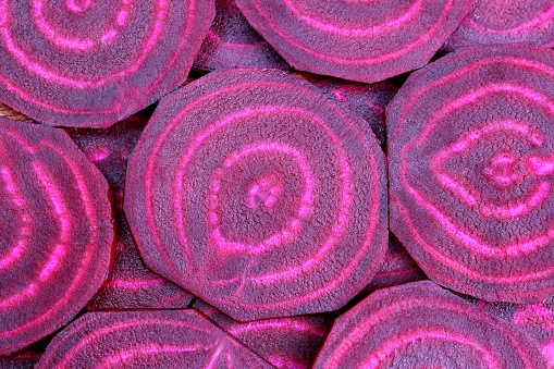 Background of red sliced beets.