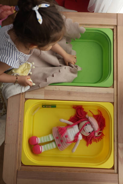 istock Little girl playing doll 1400103850