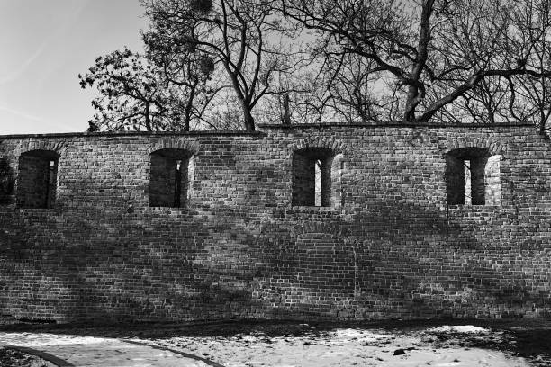 istock Fragment of a medieval brick defensive wall  during winter 1400103861