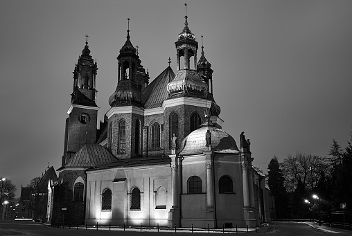 the historic towers of the Gothic cathedral at night in Poznan\