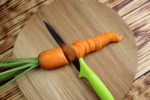 istock Carrot lies on a cutting board with a knife. 1400104506