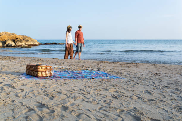 istock Couple having a romantic walk on a mediterranean beach at sunset 1400104697
