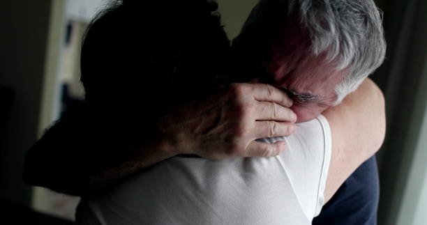 istock Senior man crying in wife shoulders 1400104954