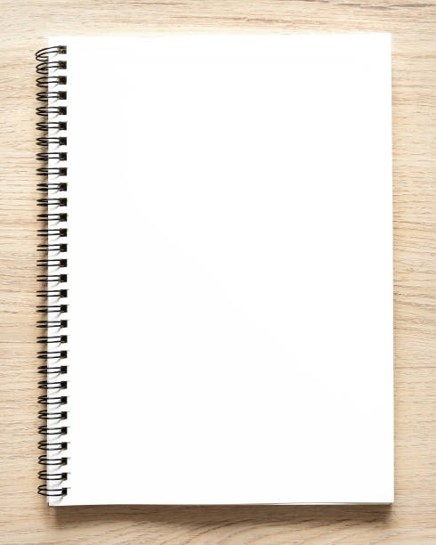 istock Blank spiral bound notepad mockup template with Kraft Paper cover, isolated on wood background. 1400105108
