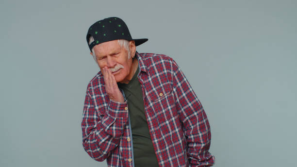 istock Man touching cheek suffering from toothache cavities or gingivitis waiting for dentist appointment 1400107833