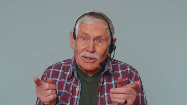 istock Senior man wearing headset freelance worker call center or support service operator helpline talk 1400107871