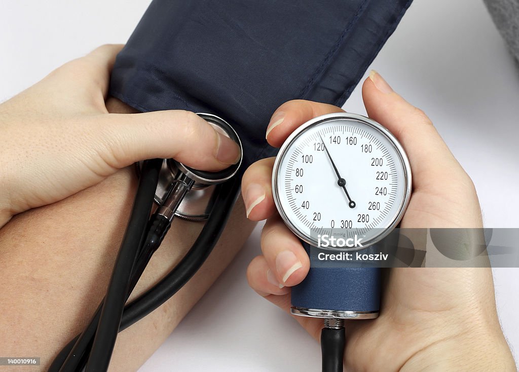 Doctor measuring blood pressure Doctor measuring blood pressure of a patient Blood Pressure Gauge Stock Photo