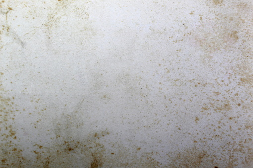 Abstract texture.Grey old sheet of paper with rusty water drops.