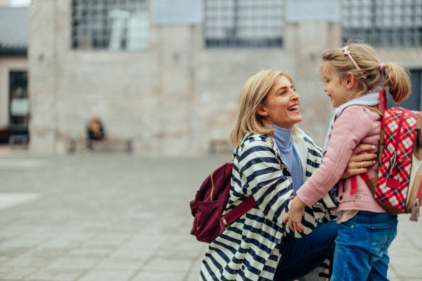 istock Mother hugging her daughter on the way to school 1400113140