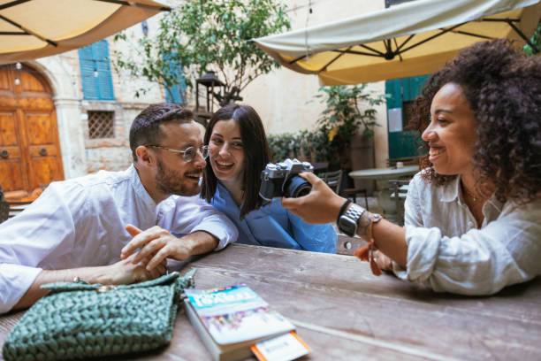 istock Three friends on vacation taking a break in a bar 1400113672