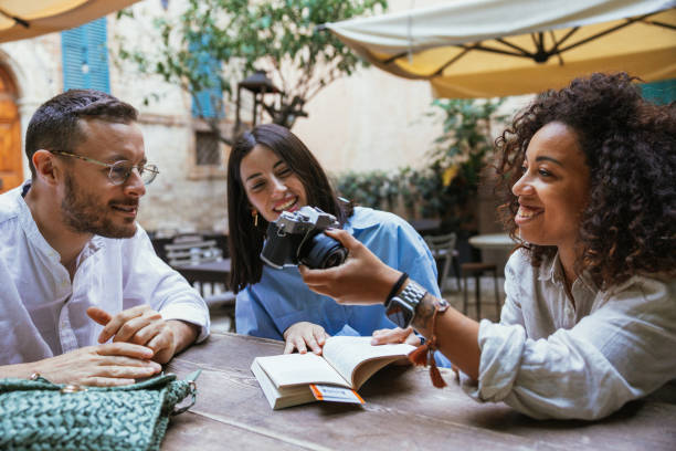 istock Three friends on vacation taking a break in a bar 1400114405