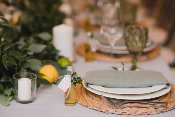 istock Table setting at the wedding reception. Floral compositions with beautiful flowers and greenery, candles, laying and plates on a decorated table. 1400116589