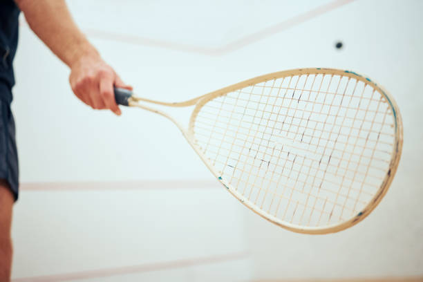istock Unknown athletic squash player using a racket to hit the ball during a game on the court. Fit active caucasian male athlete training and playing in a sports centre alone. Healthy cardio and sporty man 1400118216