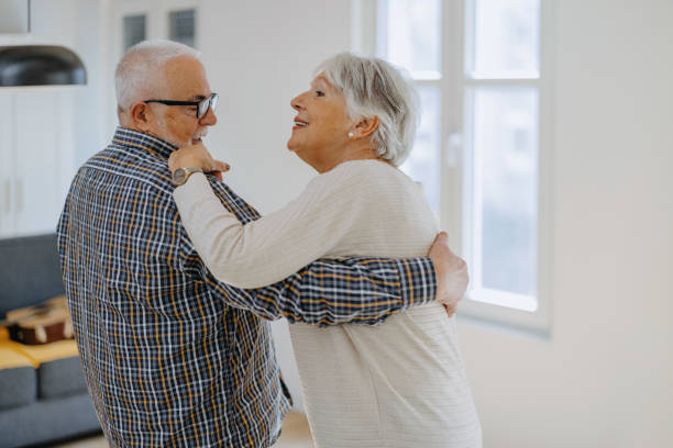 istock Senior couple dancing together at home 1400120341