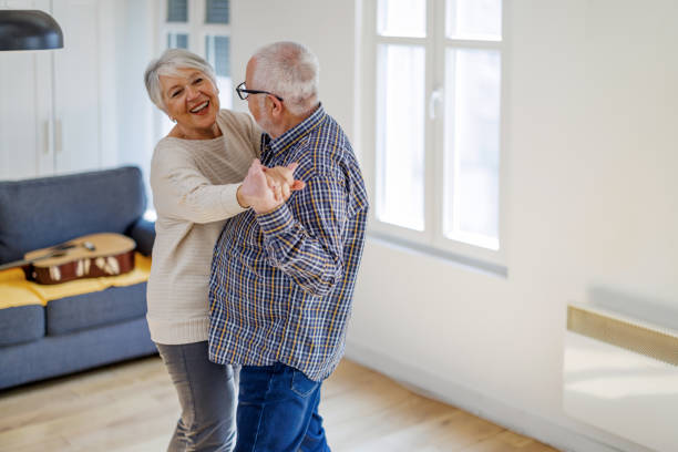 istock Senior couple dancing together at home 1400120347