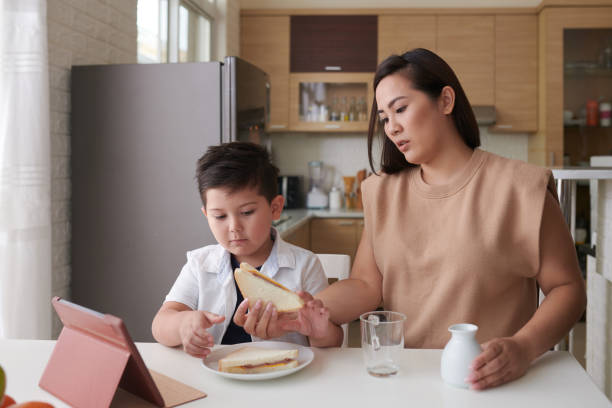 istock Mother and Son Eating Breakfast 1400120470