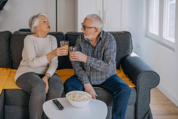 istock Senior couple watching television at home 1400120567