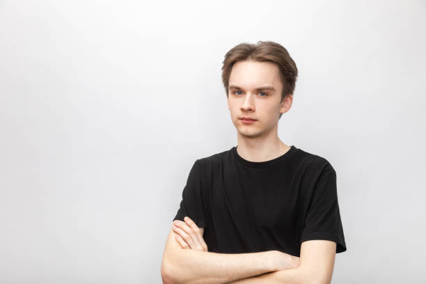 istock Suspicious young man with crossed arms studio shot on gray background 1400121377