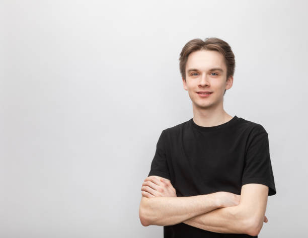 istock Cheerful young man with crossed arms studio shot on gray background 1400121397