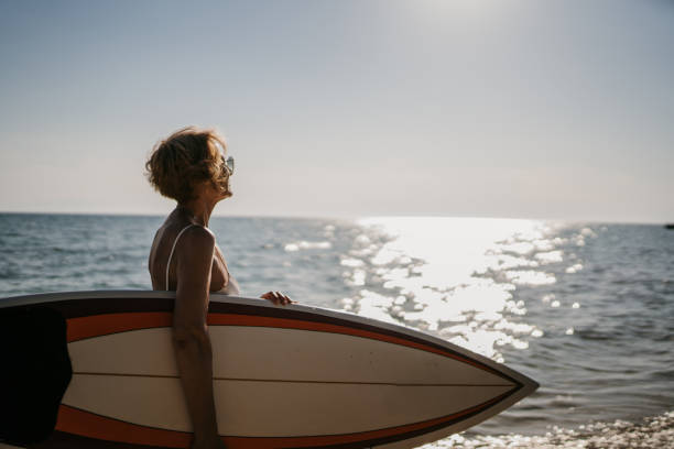 istock Female surfer by the sea 1400122774