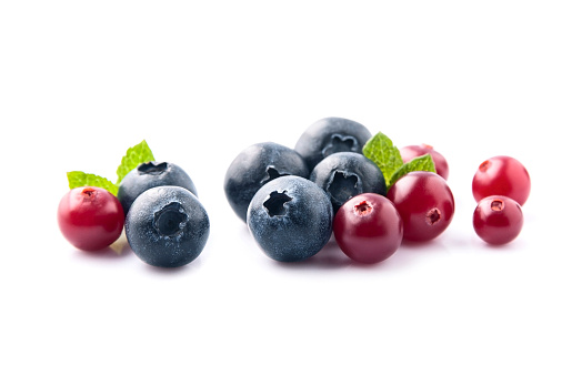 Sweet blueberries and cranberries on white backgrounds