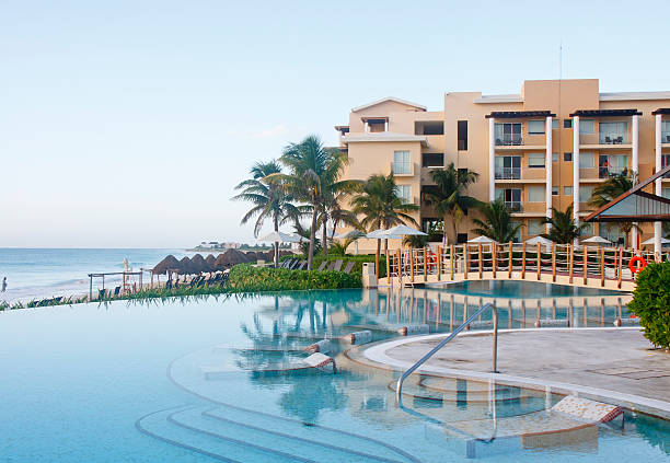 A calm resort swimming pool by a beach in the early morning