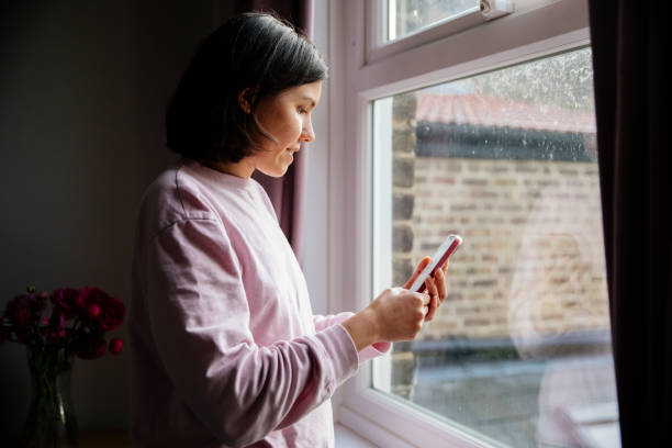 istock Woman using phone at home 1400129220
