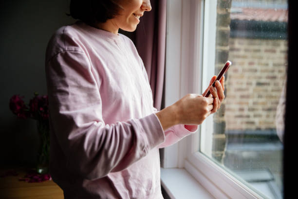istock Woman using phone at home 1400129254