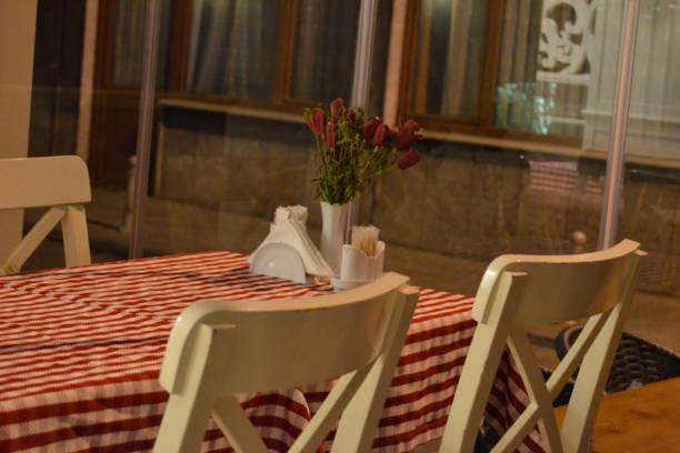 istock A dining table with 3 chairs and a red and white tablecloth 1400129330
