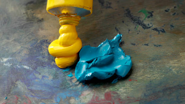 oil paint on artist palette squeezing oil paint on artist palette, selective focus oil paint palette stock pictures, royalty-free photos & images
