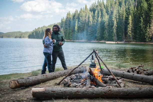 istock Couple in love standing next to campfire and talking. 1400129997
