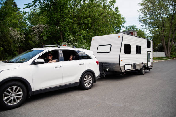 Family getting ready to leave with RV for summer vacations. stock photo