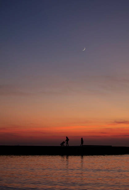 family silhouette at sunset with crescent moonwinter time - Istanbul - Turkey