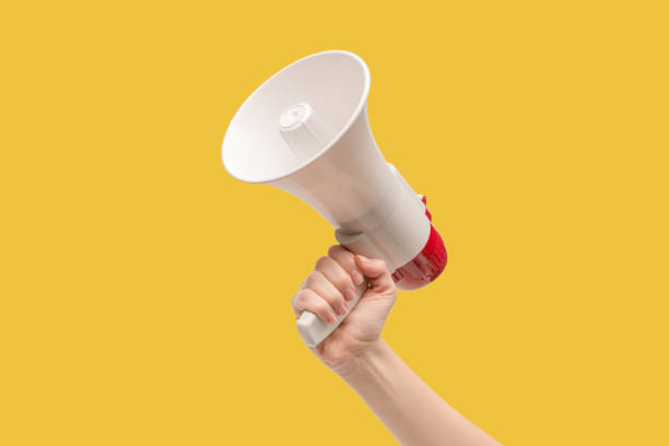 istock Megaphone in woman hands on a white background. 1400134080