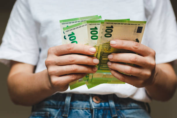 istock 100 euro banknotes in hands. 1400134760
