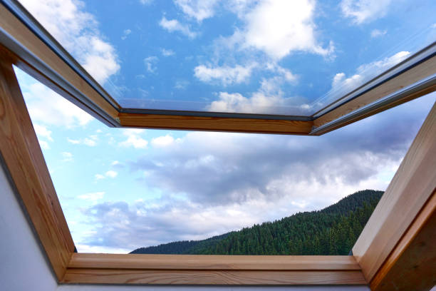 Old wooden cabin framed window with dark interior looking out into pure white background. Vintage, rustic wood theme.