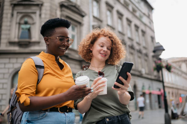 istock Two happy female tourists exploring a foreign city together 1400136579