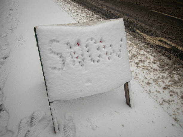 Snow marked out on a snow covered road sign