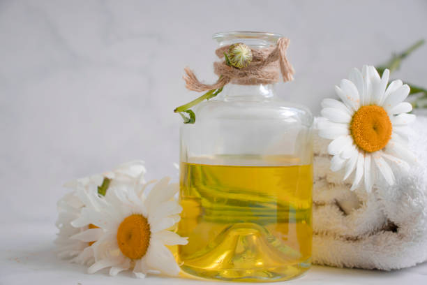istock Oil cosmetic flower chamomile on a light background 1400138069