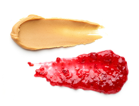 peanut butter and raspberry jam isolated on white background, top view
