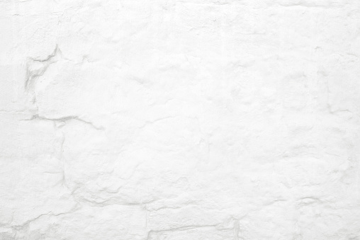 Old painted white brick close-up wall textured background, full frame. Loft-style wall