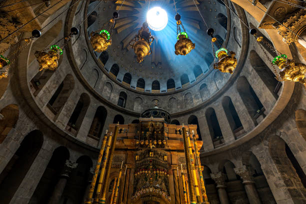 Ray of sunlight breaks through the dome over the tomb of Jesus in the Church of the Holy Sepulcher in Jerusalem, Israel. stock photo