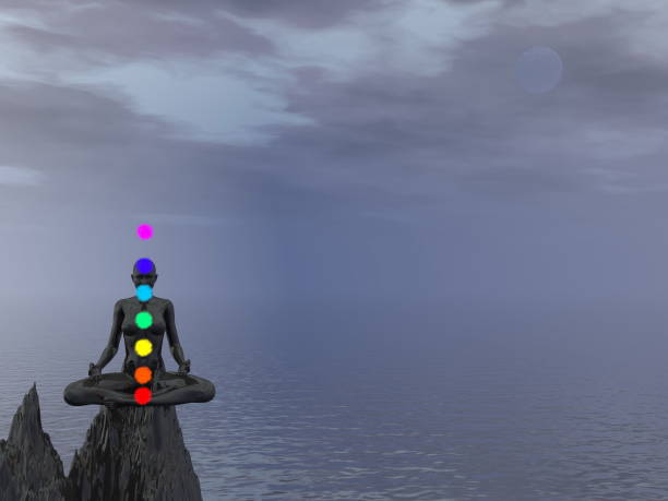 istock Woman meditating upon a rock and chakra colors - 3D render 1400141676