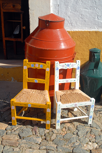 Évoramonte, Estremoz, Evora district, Alentejo, Portugal: colorful wooden chairs with floral motives - the seat is made with 'bunho', common club-rush (Schoenoplectus lacustris) -  Évora-monte.