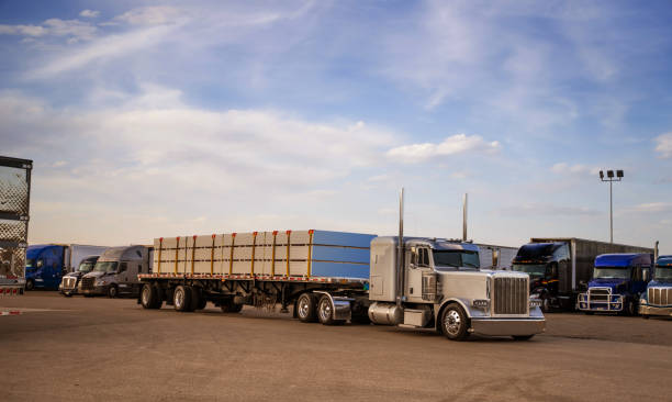 istock Truck transporting timber, leaving parking rest area - USA 1400143226